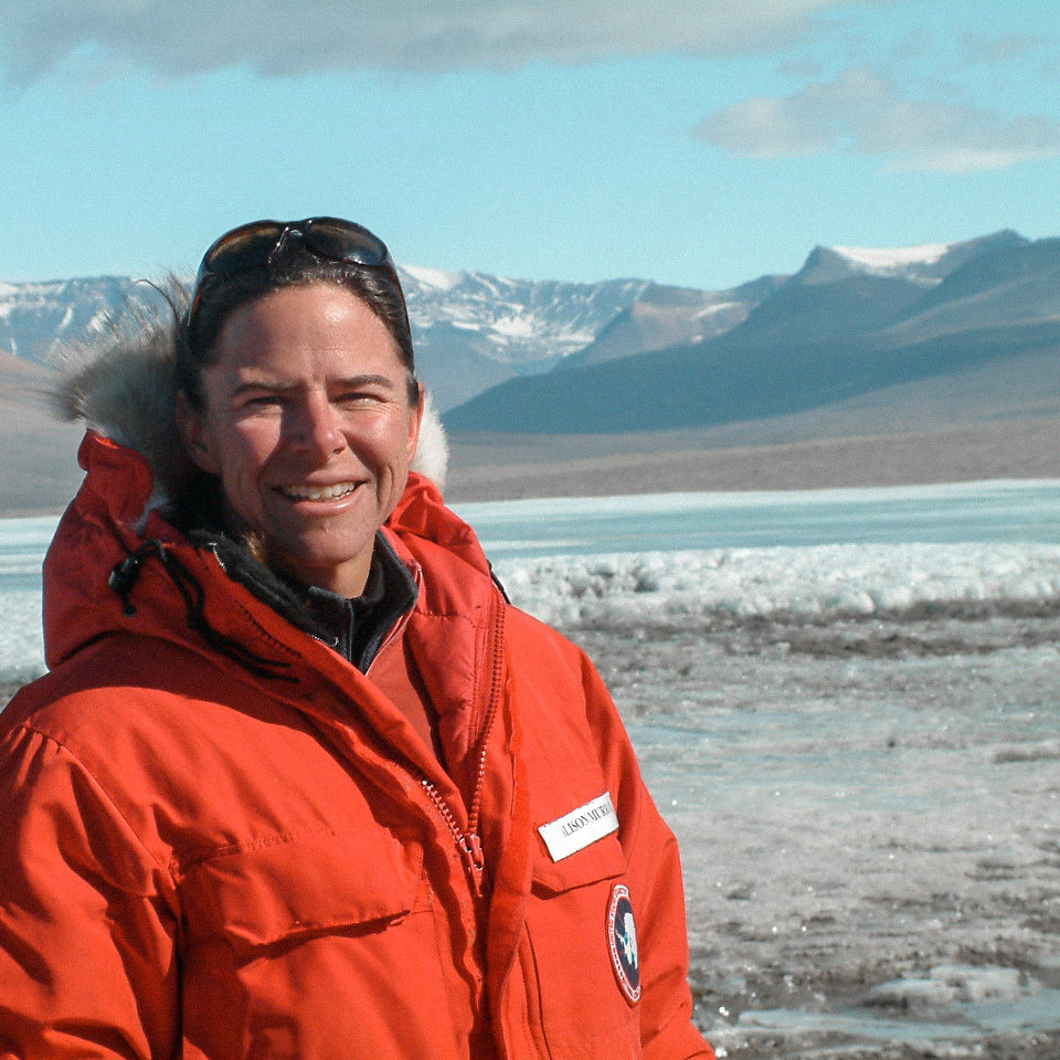 A woman (Alison Murray) in front of an Antarctic lake